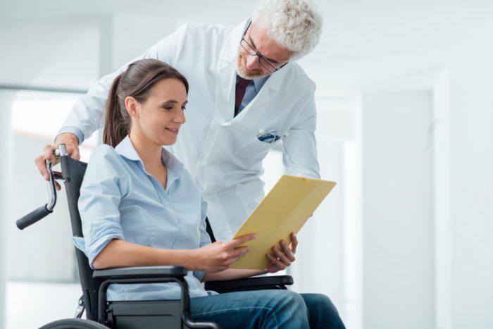 doctor-and-patient-reviewing-records-700x467